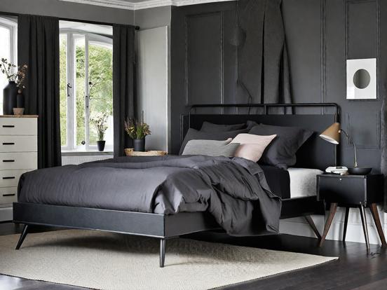 Closeup black headboard bed