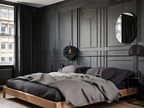 Dark cozy bedroom with mirror