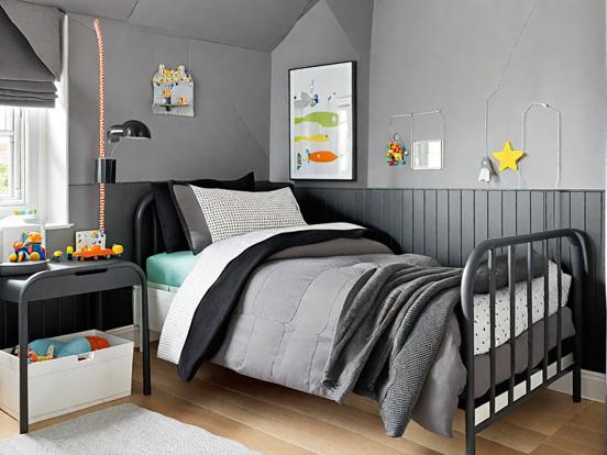 Child's bed black frame white blanket