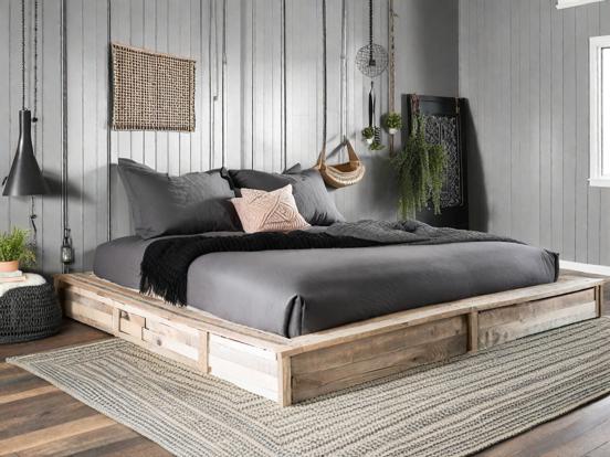 Closeup wooden bed black blanket