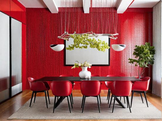 Red table chairs vase bright room