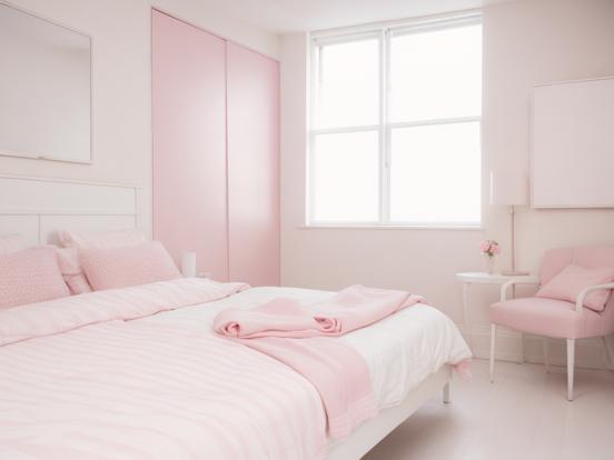 Pink girly bedroom with bed