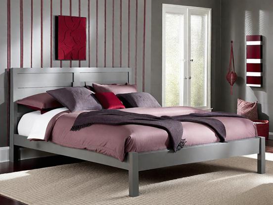 Closeup king bed red grey decor