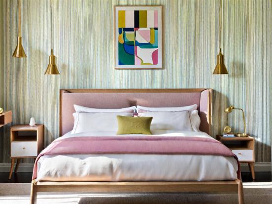 Cozy pink bed with artwork