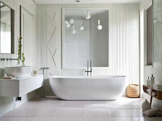 Modern white bathtub grey walls