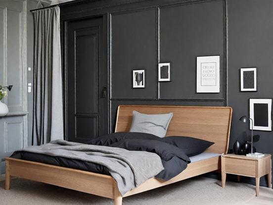 Dark bedroom with wooden bed