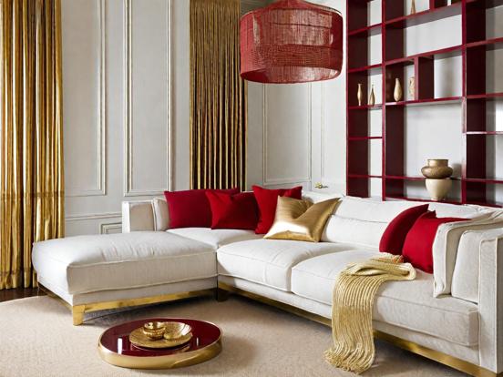 White couch red pillows gold table