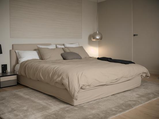 Beige bed with pillows in room