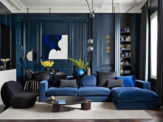 Bright blue room black sofa