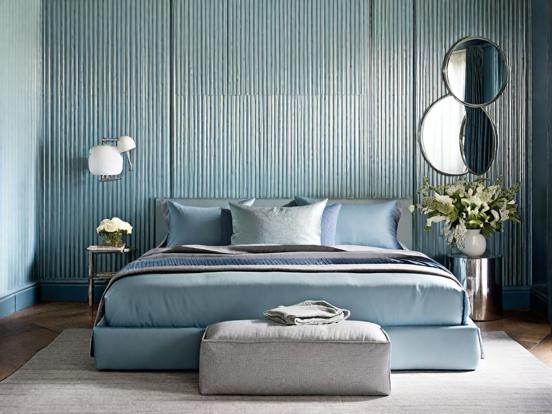 Blue bed cover grey wall room