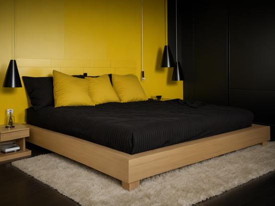 Yellow black bed white rug