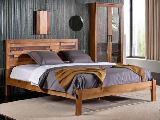 Closeup wooden bed with blanket