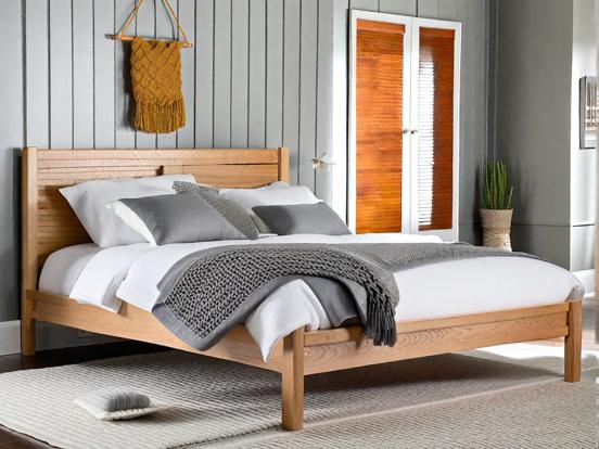 Closeup wooden bed white linen