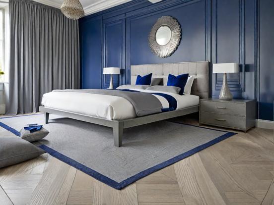 Blue bedroom white bed oak floor