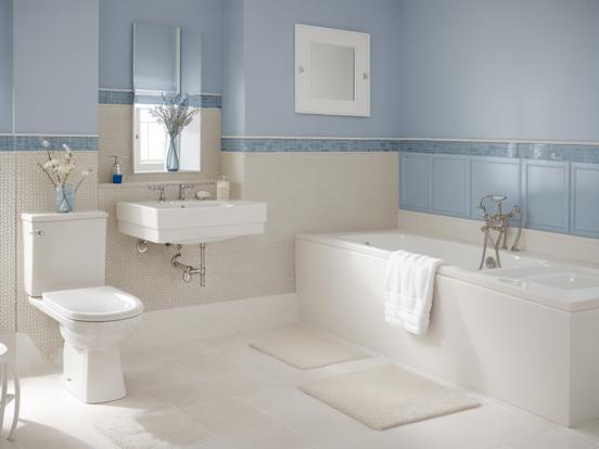 White toilet by bathtub blue cream