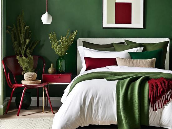 Bed with green blanket red chair