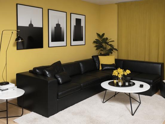 Black leather couch yellow room