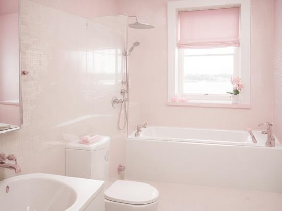 White toilet by pink bathtub