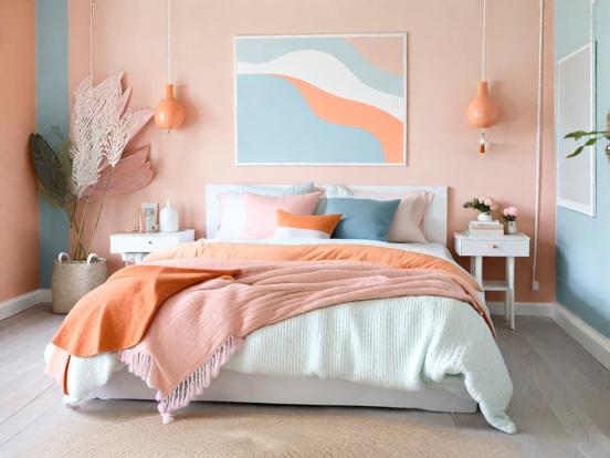 Cozy bed in bright pink room