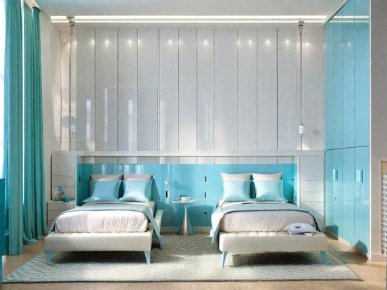 Two beds in blue room