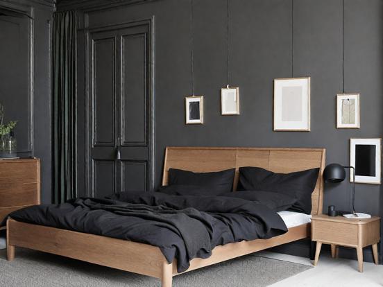 Dark bedroom with black bed